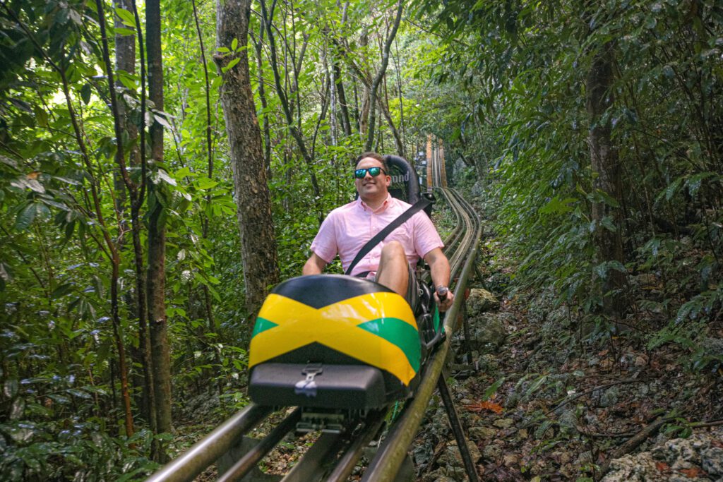 An adrenaline-pumping image of a person riding through the mountainous terrain of Mystic Mountain Nature Park in Ocho Rios, Jamaica.
