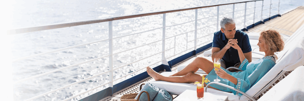 A couple aboard Regent's cruise line enjoying exceptional service and fewer guests. 